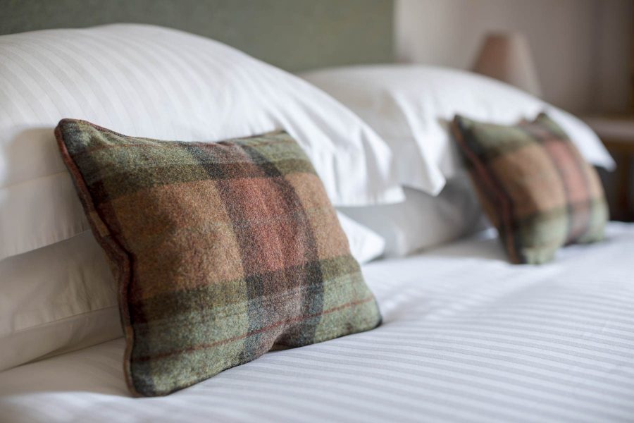 Tartan pillows on a bed in our dog friendly accommodation