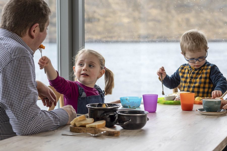 A father sitting with his two children in the Kylesku Hotel restaurant
